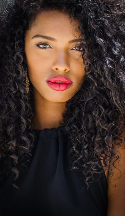 Fashionable black woman with red lips posing looking at camera